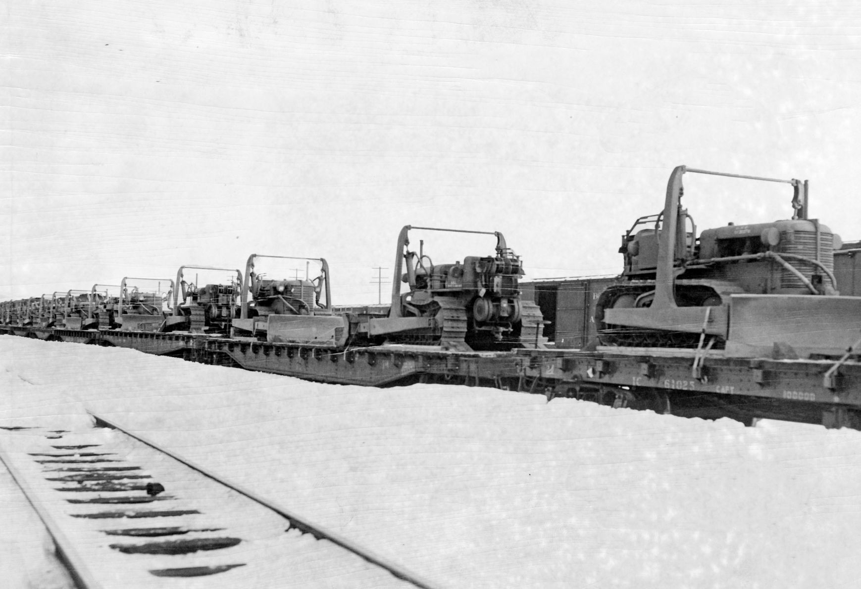 Eight flatcars of bulldozers, two per car, are headed for the storm-struck areas of Nebraska. This photo was taken at the Council Bluffs Union Pacific yard. Published Jan. 30, 1949.